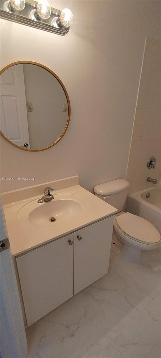 22911 Southwest 88th Place, Unit 721 Cutler Bay, FL 33190 - Photo 15 of 20 a bathroom with a sink a toilet and a mirror
