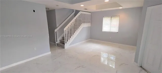 a view of an empty room with a window