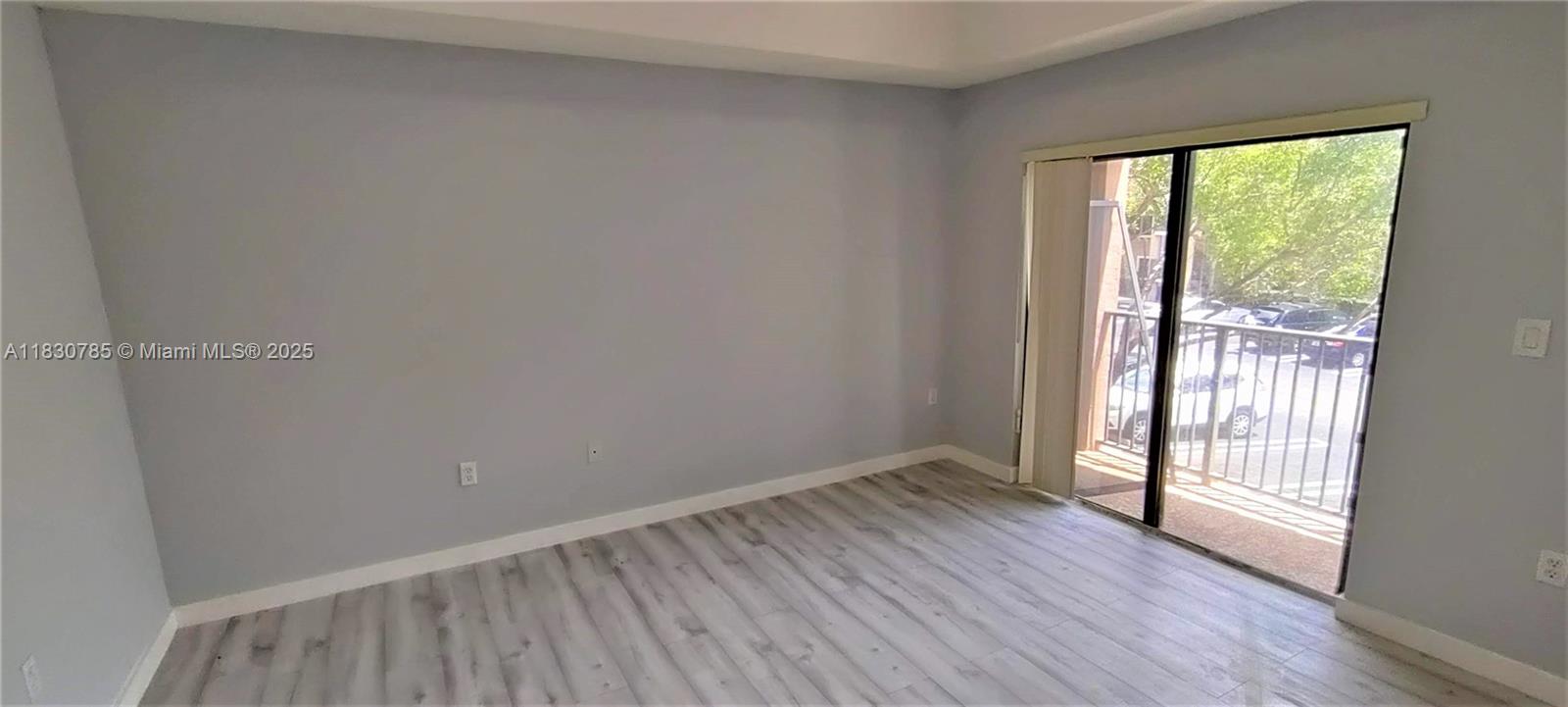 22911 Southwest 88th Place, Unit 721 Cutler Bay, FL 33190 - Photo 10 of 20 an empty room with wooden floor and windows