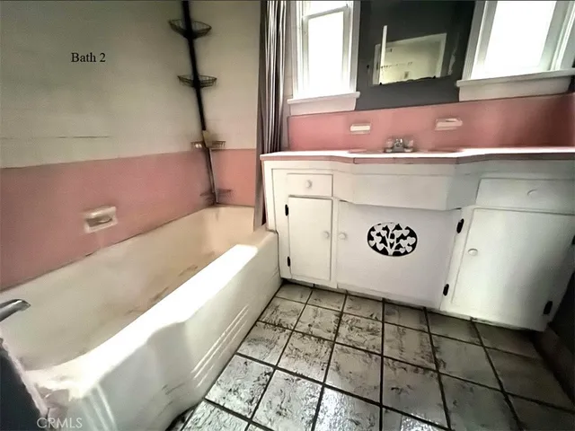 a bathroom with a bathtub and a sink