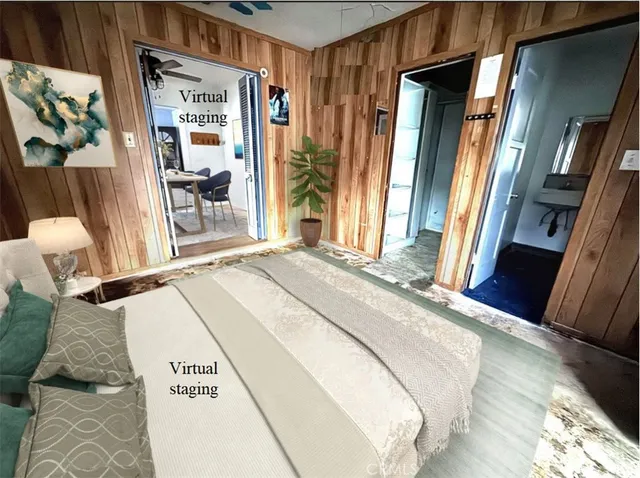 a bedroom with a bed and a large mirror next to a window