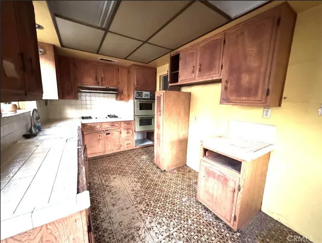 a kitchen with a refrigerator and a stove