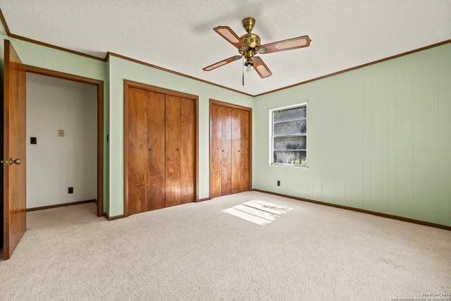 a view of a livingroom with a ceiling fan and window