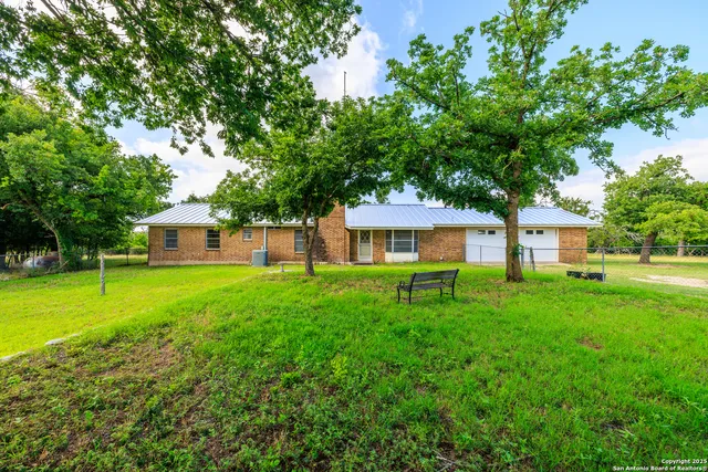 a view of a house with a backyard