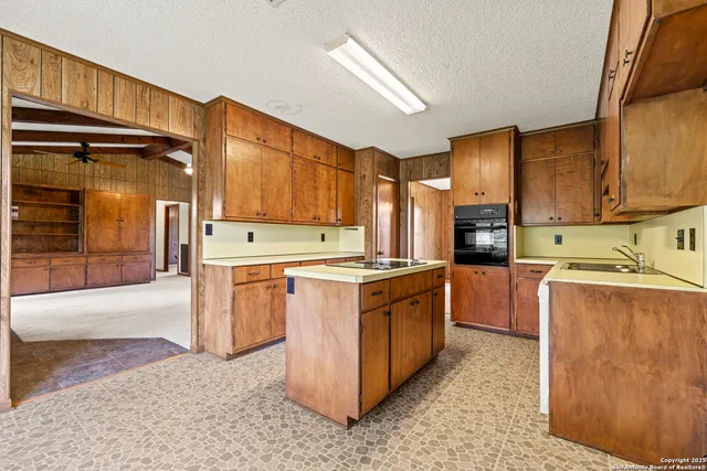a kitchen with stainless steel appliances granite countertop a stove refrigerator and a sink