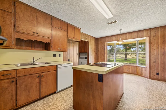 a kitchen with a sink stove and cabinets