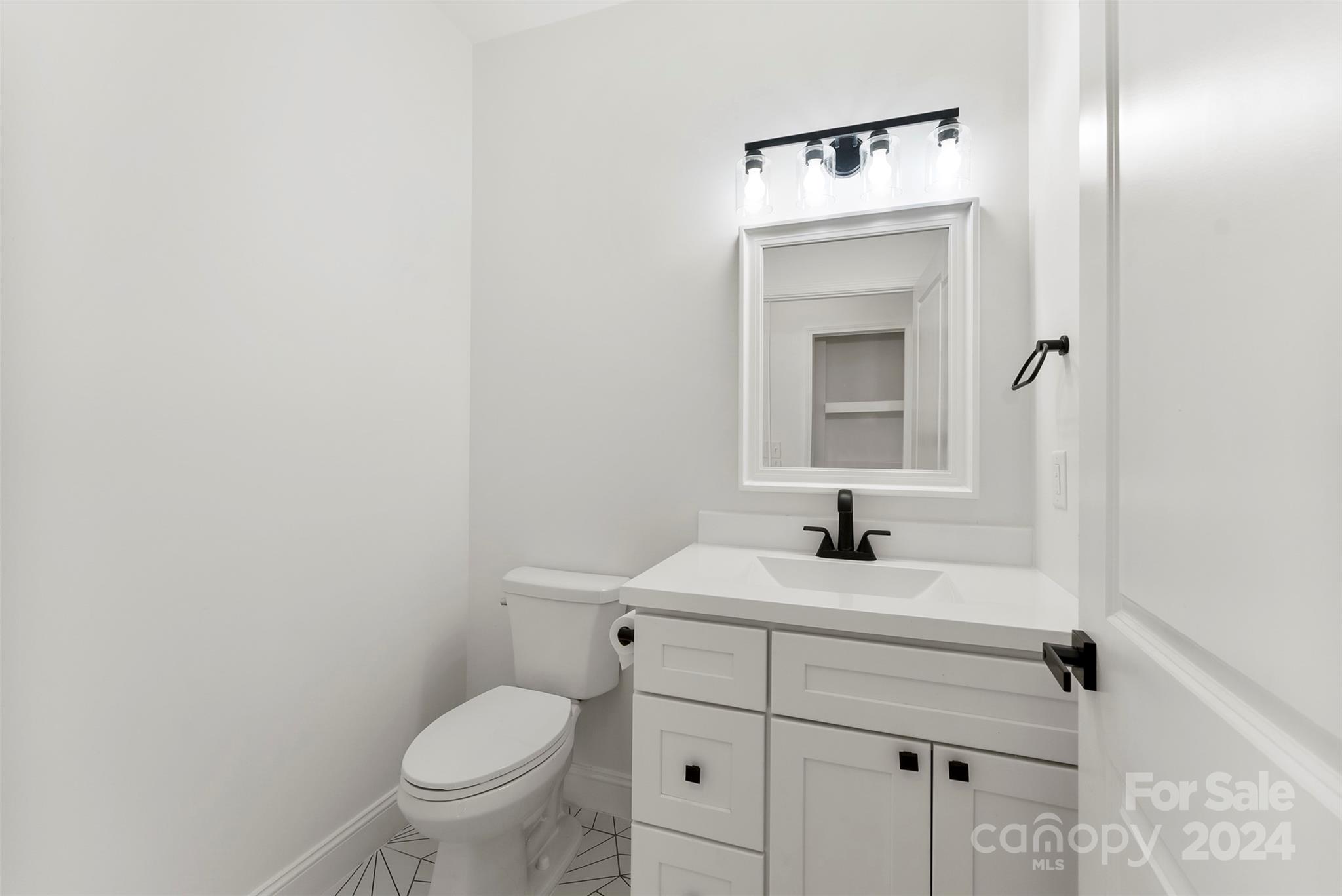 1129 Stoney Point Road Kings Mountain, NC 28086 - Photo 8 of 45 a bathroom with a toilet sink and mirror