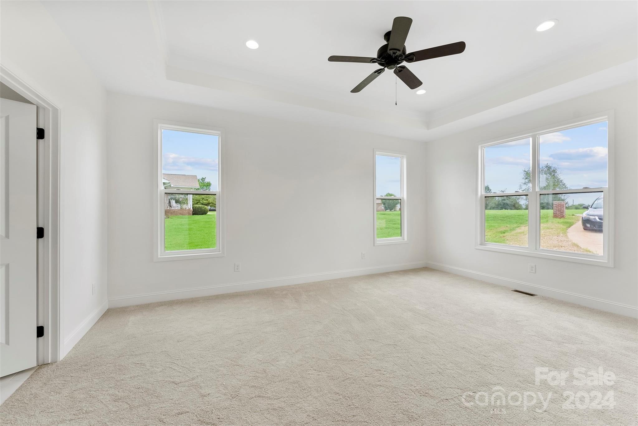 1129 Stoney Point Road Kings Mountain, NC 28086 - Photo 9 of 45 an empty room with windows and ceiling fan