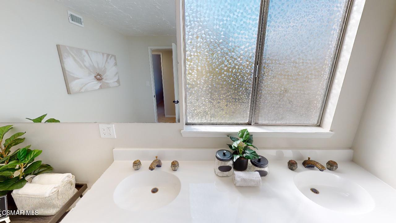 2007 Rhoda Street Simi Valley, CA 93065 - Photo 40 of 52 a bathroom with a sink a mirror and a bathtub