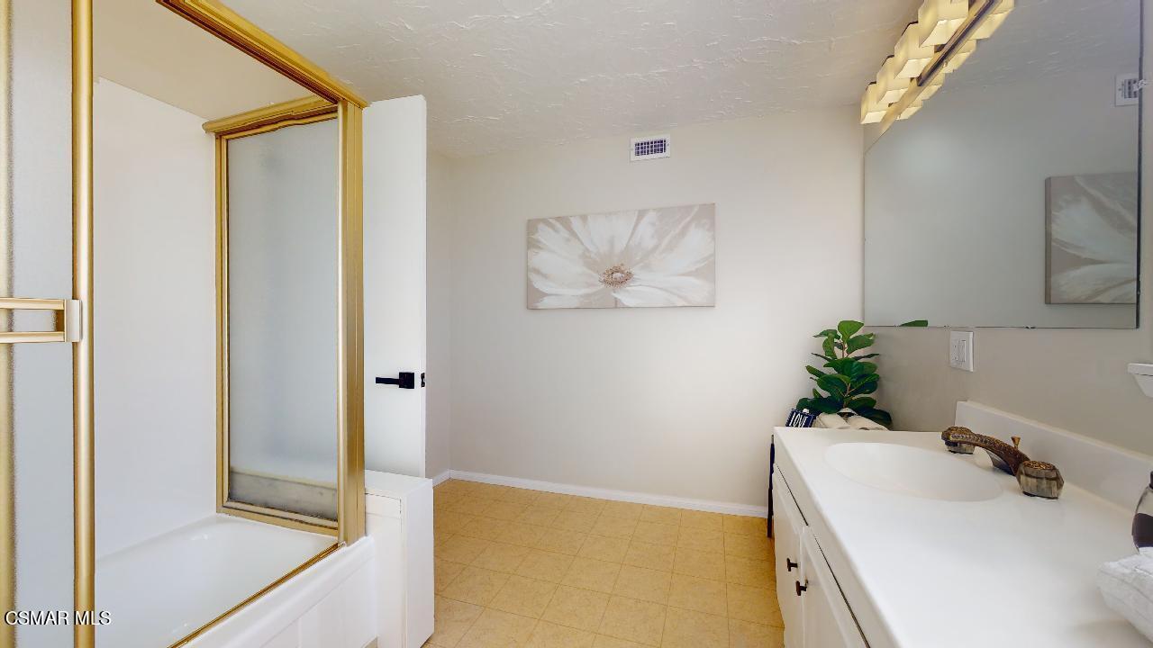 2007 Rhoda Street Simi Valley, CA 93065 - Photo 42 of 52 a bathroom with a tub sink and mirror