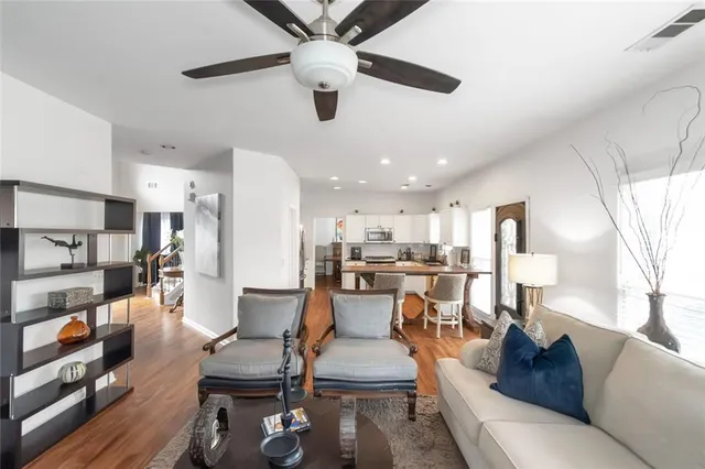 a living room with furniture and a wooden floor