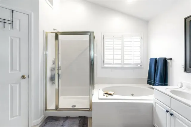 a bathroom with a bathtub sink and mirror
