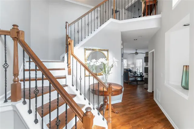 a view of staircase with lots of furniture and a wooden floor