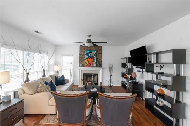 a living room with furniture a flat screen tv and a fireplace