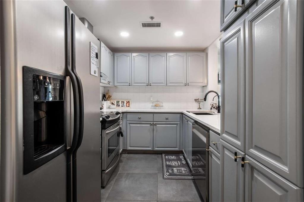 3475 Oak Valley Road Northeast, Unit 1630 Atlanta, GA 30326 - Photo 15 of 38 a kitchen with a refrigerator sink and cabinets