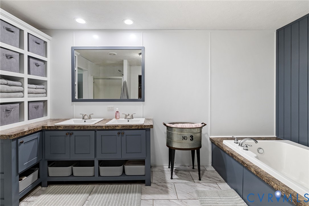 11391 Watkins Road Rockville, VA 23146 - Photo 23 of 28 a bathroom with a tub sink and mirror