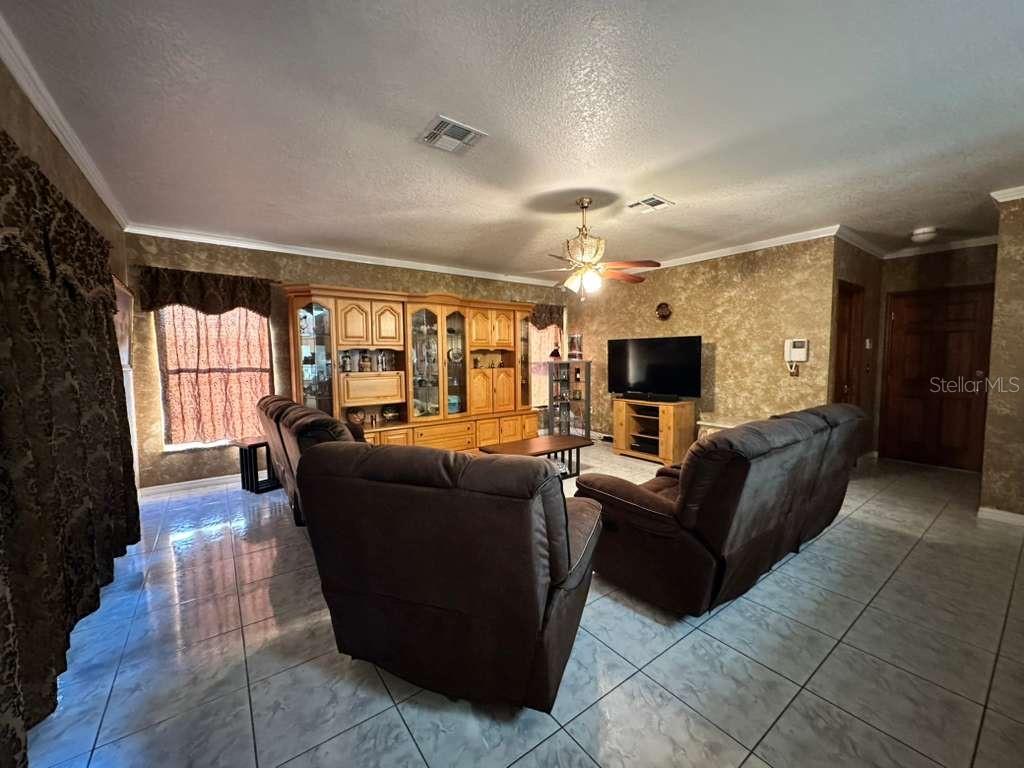 607 Gaul Way Kissimmee, FL 34759 - Photo 11 of 30 a living room with furniture and a flat screen tv