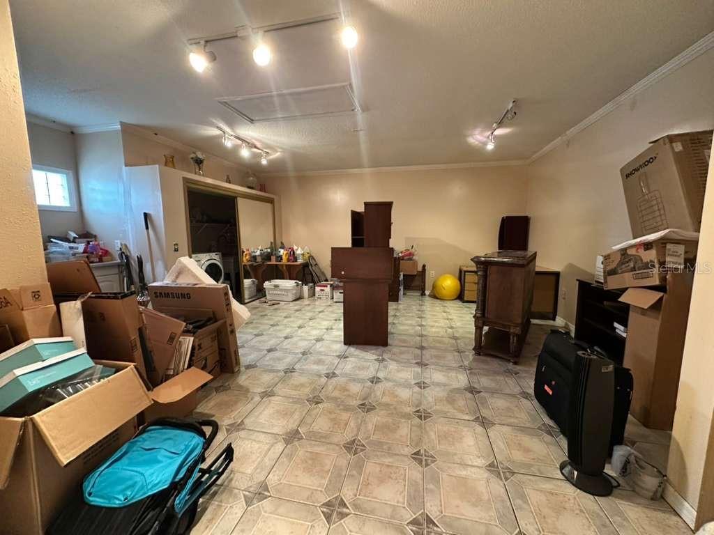 607 Gaul Way Kissimmee, FL 34759 - Photo 13 of 30 a living room with furniture a flat screen tv and kitchen view