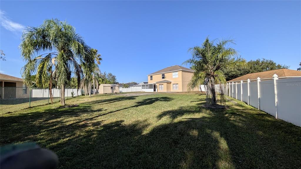 607 Gaul Way Kissimmee, FL 34759 - Photo 19 of 30 a view of a house with a yard and basketball court
