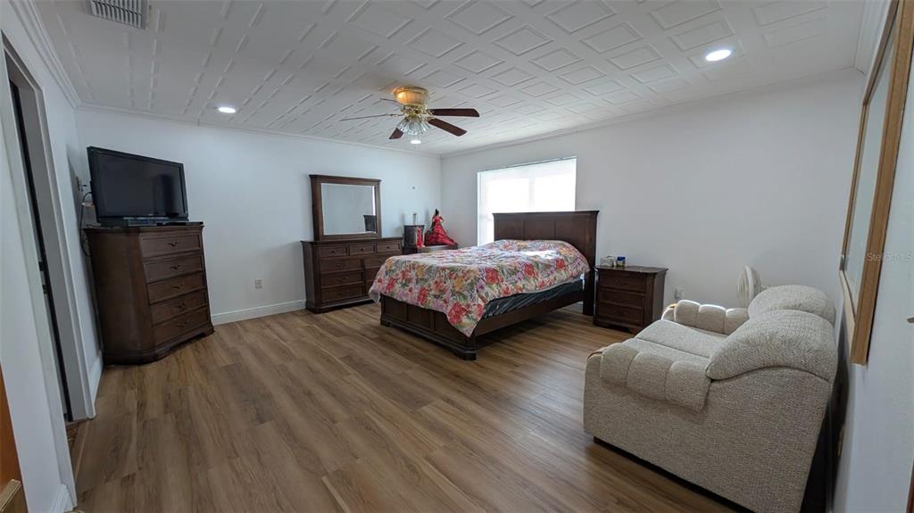 607 Gaul Way Kissimmee, FL 34759 - Photo 23 of 30 a bedroom with bed and a flat screen tv