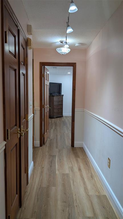 607 Gaul Way Kissimmee, FL 34759 - Photo 27 of 30 a view of a hallway with wooden floor and chandelier
