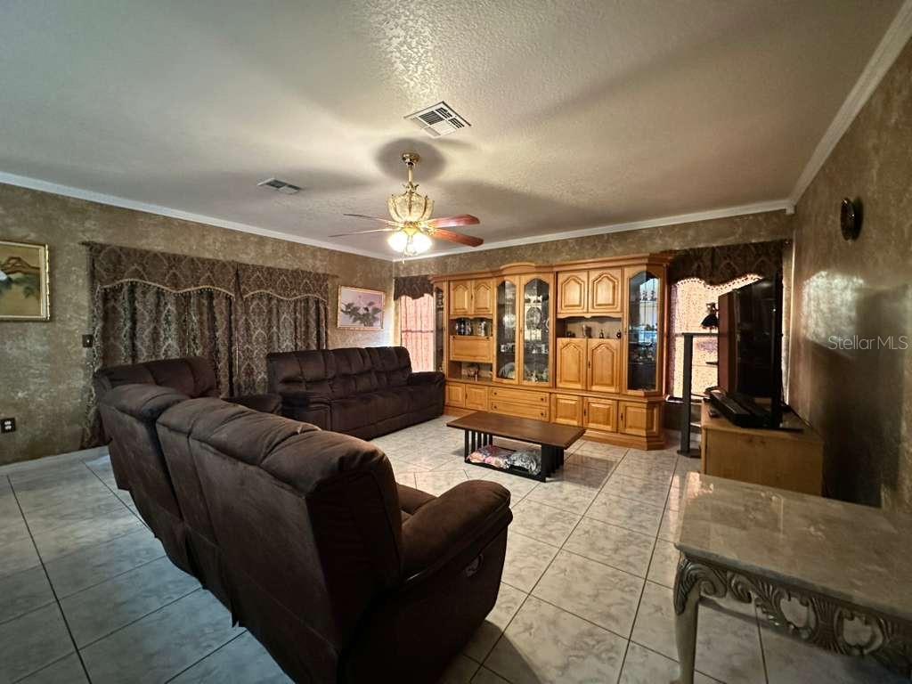607 Gaul Way Kissimmee, FL 34759 - Photo 3 of 30 a living room with furniture and wooden floor