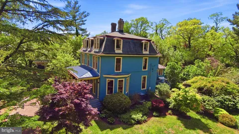 a view of a house with a yard and garden