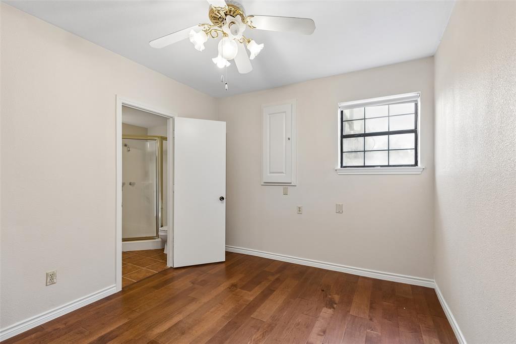 4 Eastshore Road Heath, TX 75032 - Photo 23 of 37 an empty room with wooden floor and windows