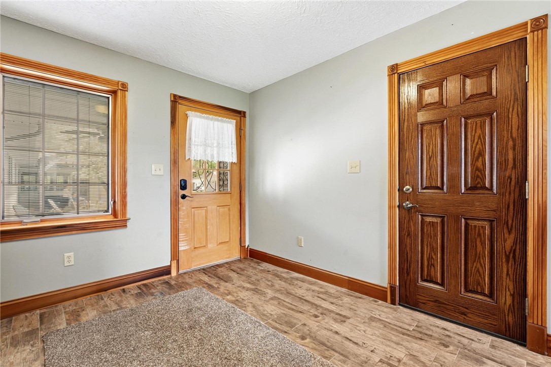 4971 Lackey Road Cedarville, OH 45314 - Photo 56 of 79 This inviting entry features durable flooring, a functional window, and a paneled door.
