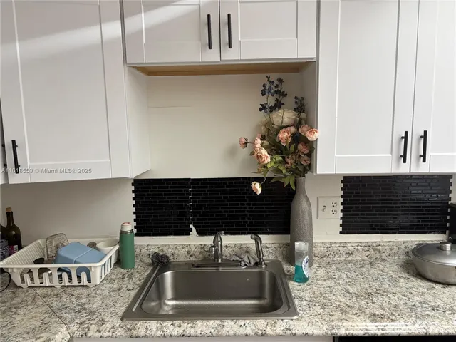a kitchen with a sink and a stove