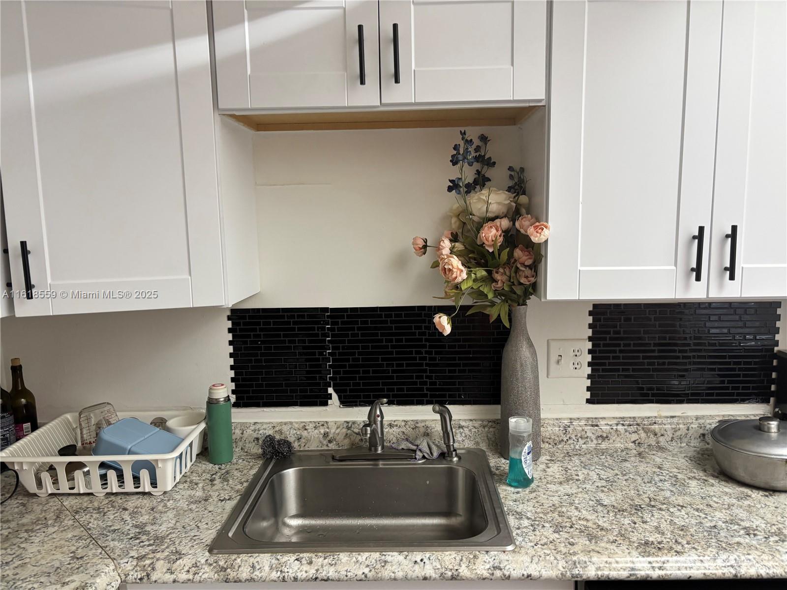 4168 Inverrary Drive, Unit 302 Lauderhill, FL 33319 - Photo 13 of 25 a kitchen with a sink and a stove