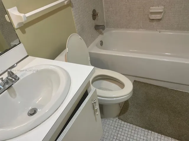 a bathroom with a toilet a sink and a bathtub