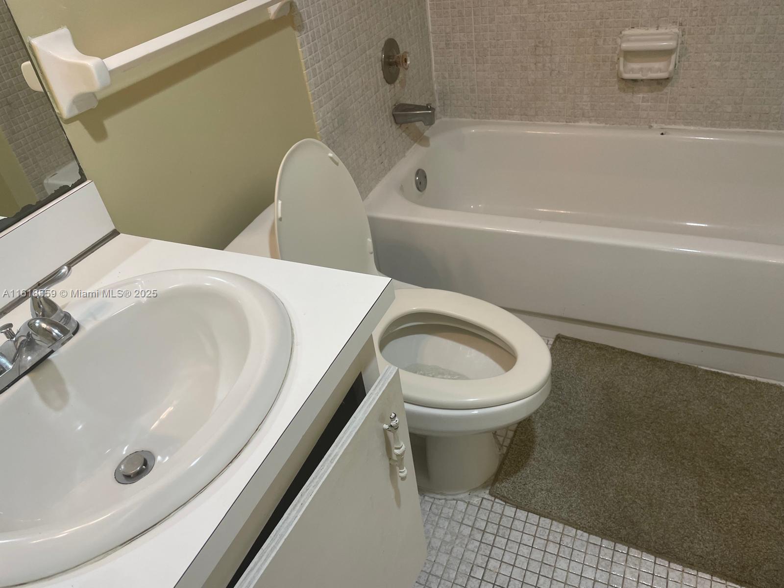 4168 Inverrary Drive, Unit 302 Lauderhill, FL 33319 - Photo 17 of 25 a bathroom with a sink and a toilet
