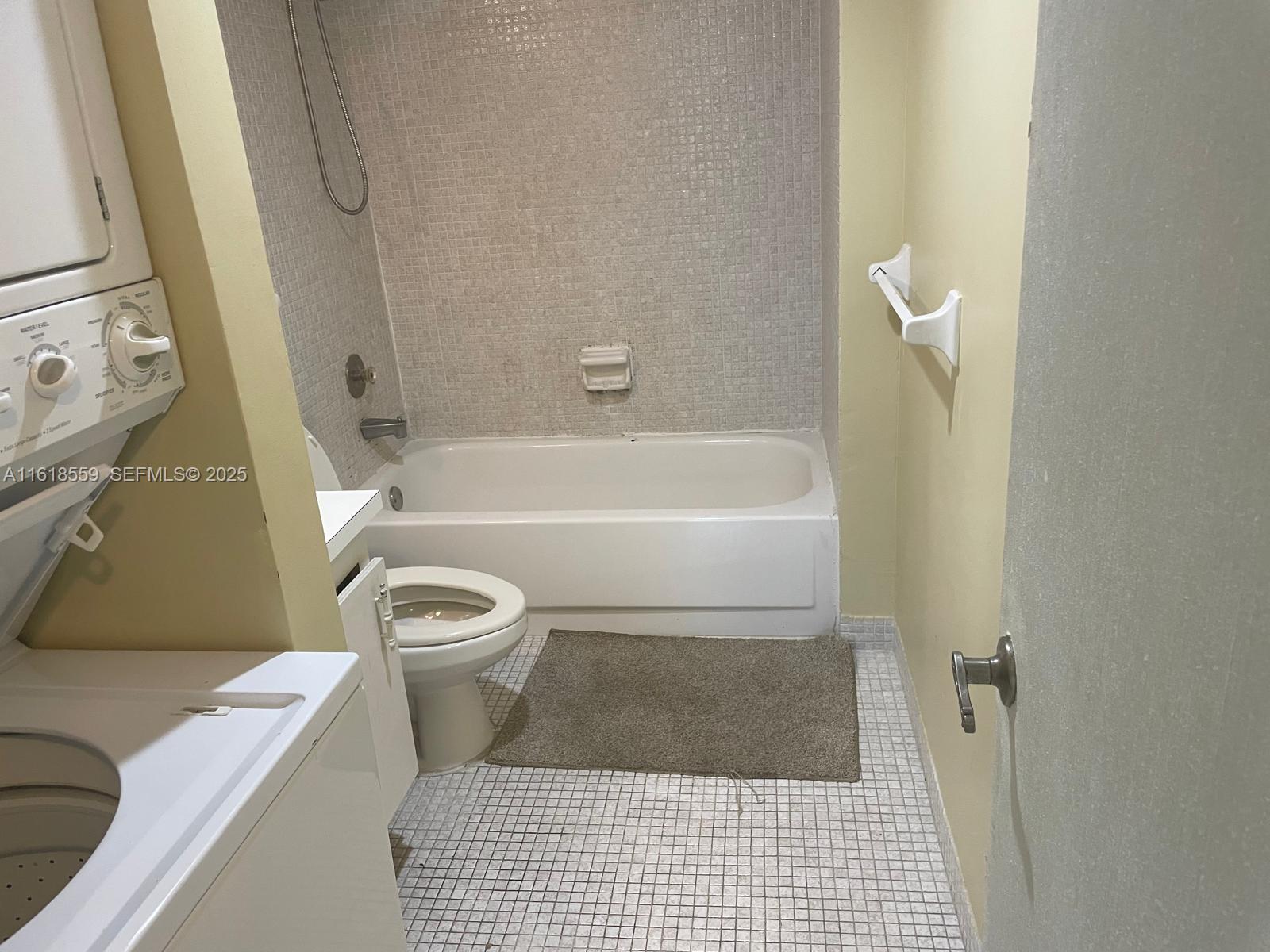 4168 Inverrary Drive, Unit 302 Lauderhill, FL 33319 - Photo 18 of 25 a bathroom with a toilet a sink and a bathtub