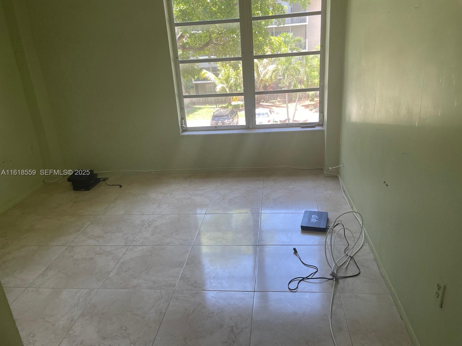 4168 Inverrary Drive, Unit 302 Lauderhill, FL 33319 - Photo 20 of 25 a view of a small space with wooden floor and a window