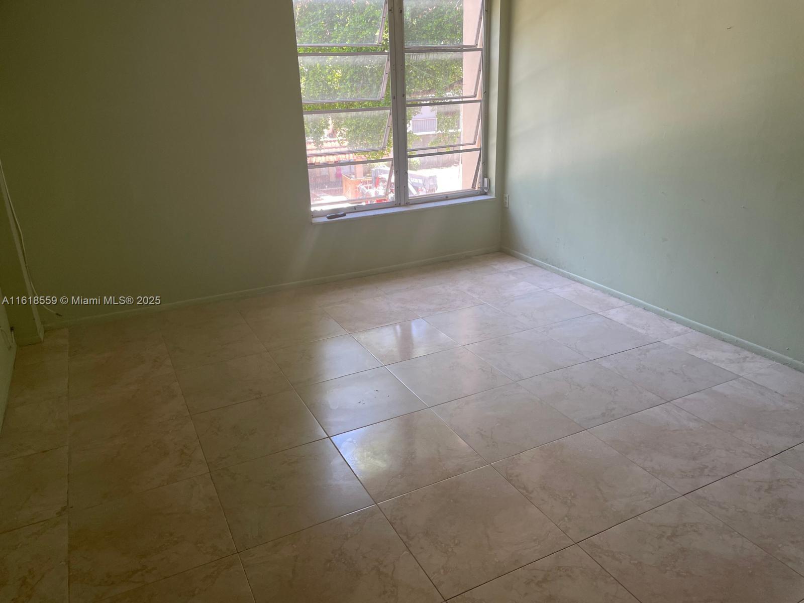 4168 Inverrary Drive, Unit 302 Lauderhill, FL 33319 - Photo 21 of 25 an empty room with windows