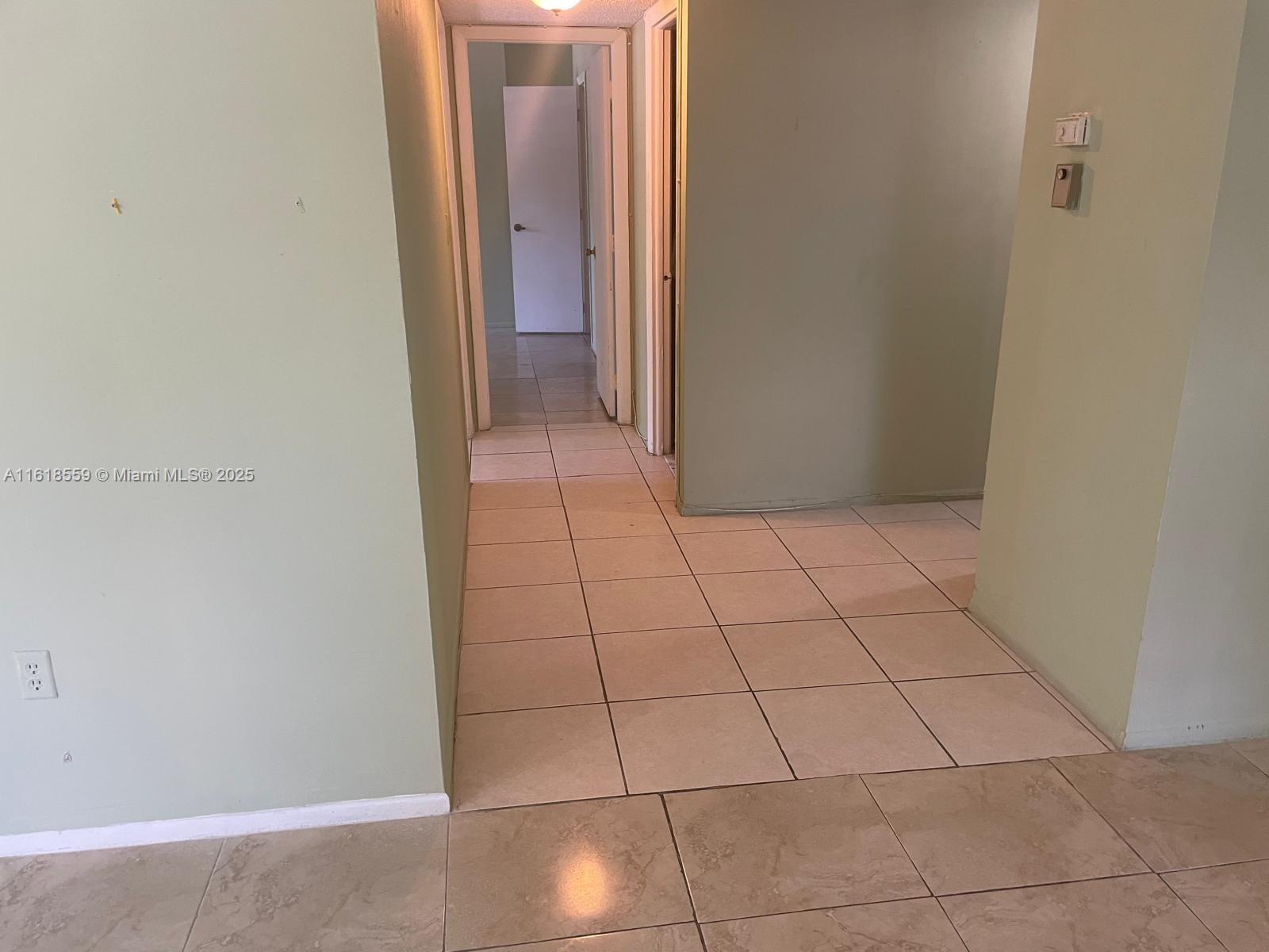 4168 Inverrary Drive, Unit 302 Lauderhill, FL 33319 - Photo 22 of 25 a view of a livingroom with an empty space and a hallway