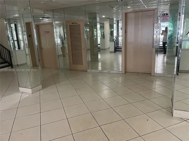 a view of a refrigerator and an empty room