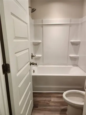 a bathroom with a bathtub and a toilet