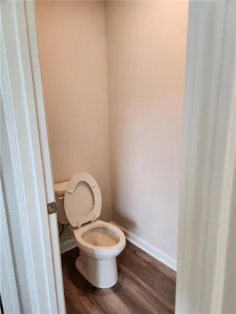 a view of a hallway with wooden floor and a window