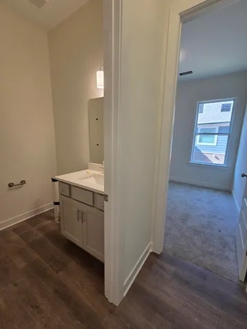 a room with a sink and mirror