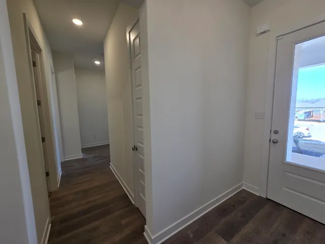 a view of hallway with wooden floor