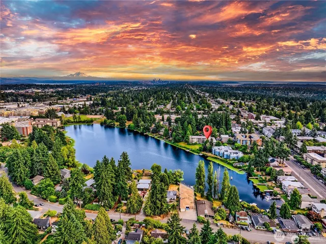 a view of a big room with windows and chandelier
