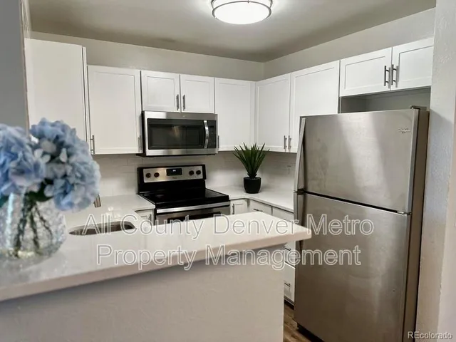a white refrigerator freezer sitting in a kitchen