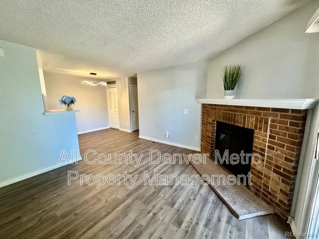 a view of an empty room with a fireplace