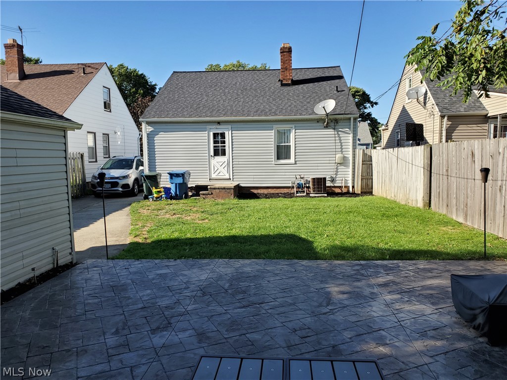 5615 Ridgewood Avenue Parma, OH 44129 - Photo 18 of 19 Back door to yard. All concrete along driveway side of house has been replaced when waterproofed. Central air