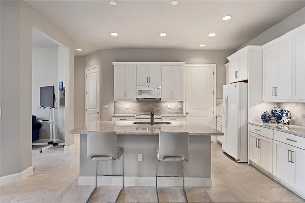 a kitchen with a sink stove and refrigerator
