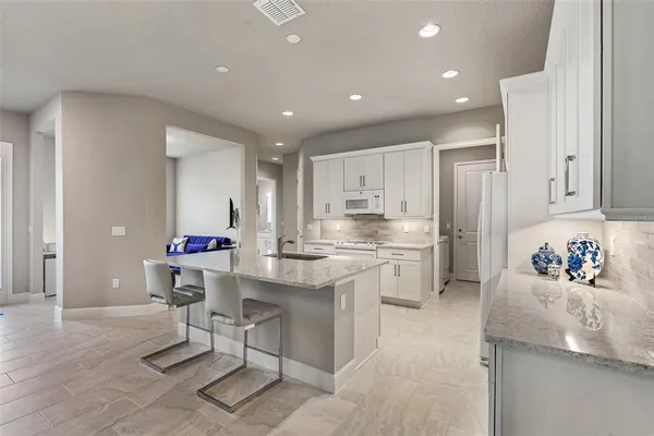 a large white kitchen with a large window