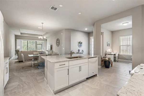 a view of a dining room with furniture and chandelier