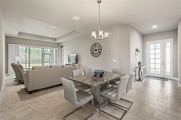 a living room with furniture a flat screen tv and a large window